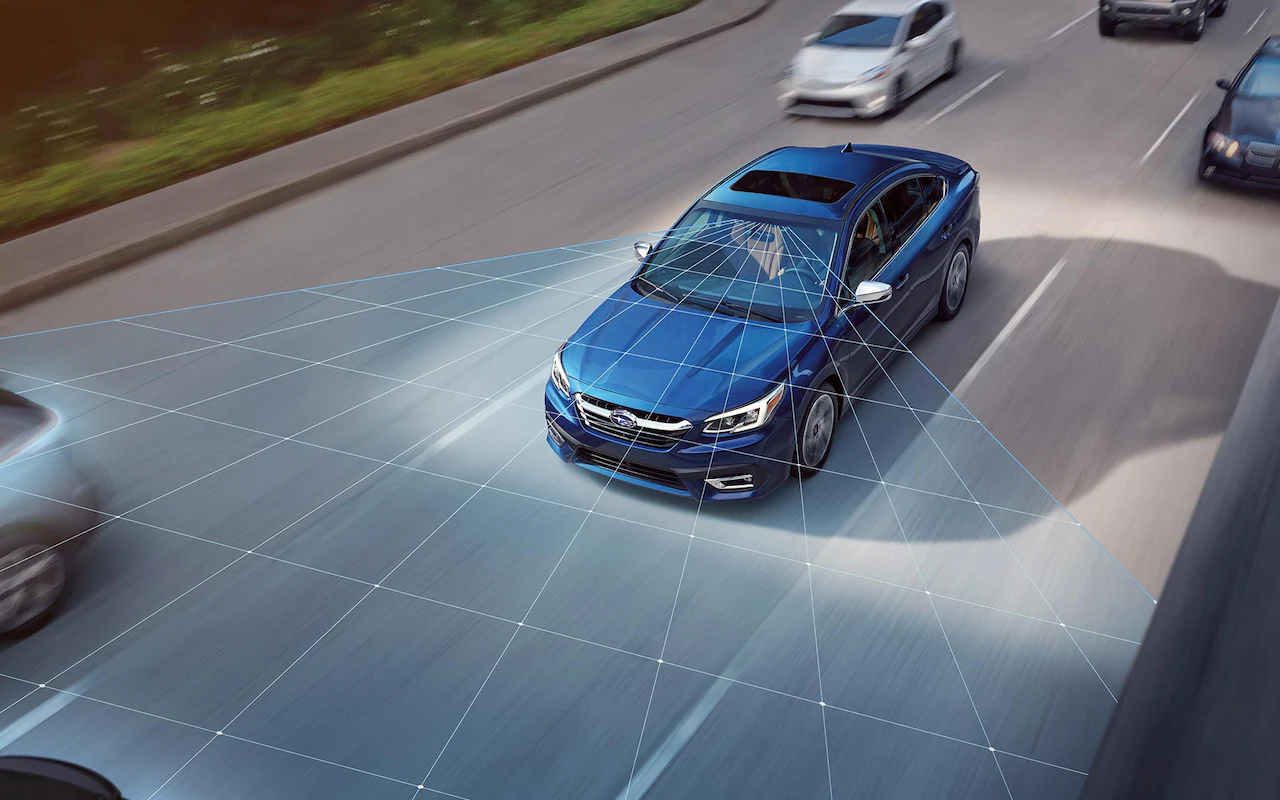 A photo illustration showing the EyeSight® Driver Assist Technology sensors on a 2022 Subaru Legacy driving down a highway.